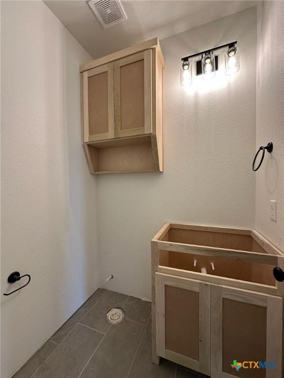 bathroom with tile patterned flooring and visible vents