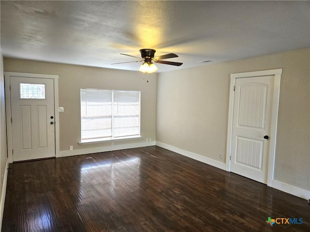 interior space featuring wood finished floors, baseboards, and ceiling fan
