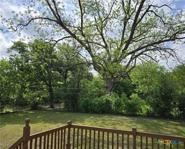 deck featuring a yard and a fenced backyard