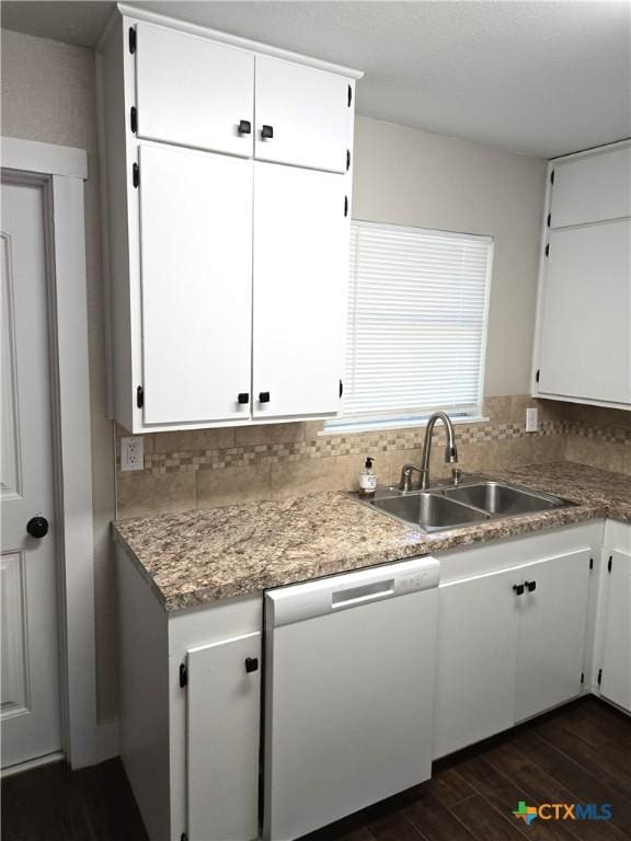 kitchen with decorative backsplash, dishwasher, dark wood-style floors, and a sink