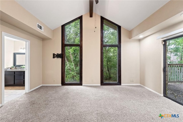 interior space featuring light carpet and lofted ceiling with beams