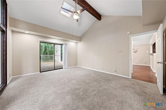 spare room featuring carpet flooring, ceiling fan, and vaulted ceiling with skylight