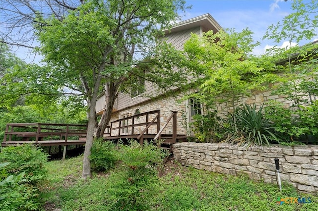 rear view of house with a wooden deck