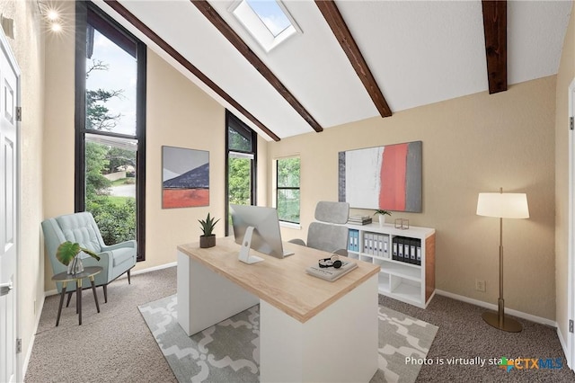 carpeted office with beamed ceiling, a skylight, and high vaulted ceiling