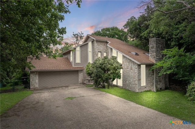 view of front of house with a lawn and a garage