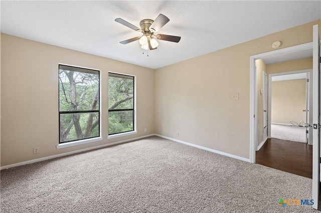 unfurnished room with ceiling fan and carpet floors