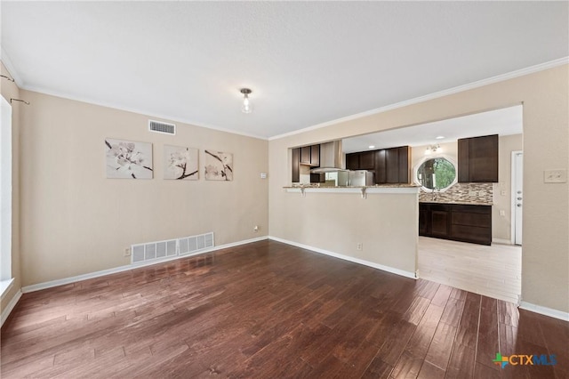 unfurnished room with wood-type flooring and ornamental molding