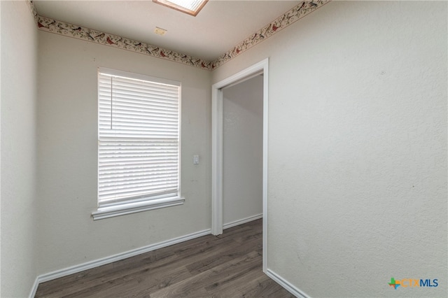 unfurnished room featuring dark hardwood / wood-style flooring