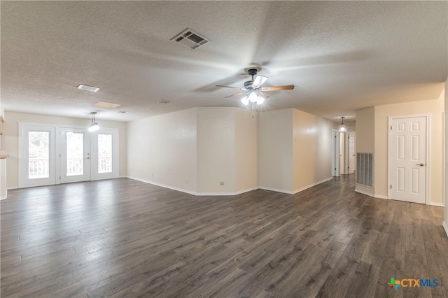 unfurnished room featuring a textured ceiling, dark hardwood / wood-style floors, and ceiling fan