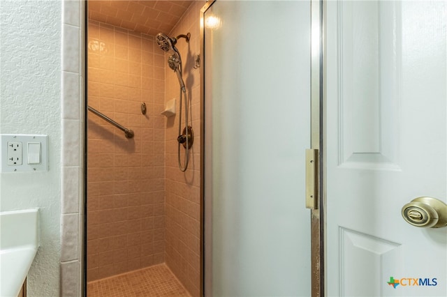 bathroom with a shower with door