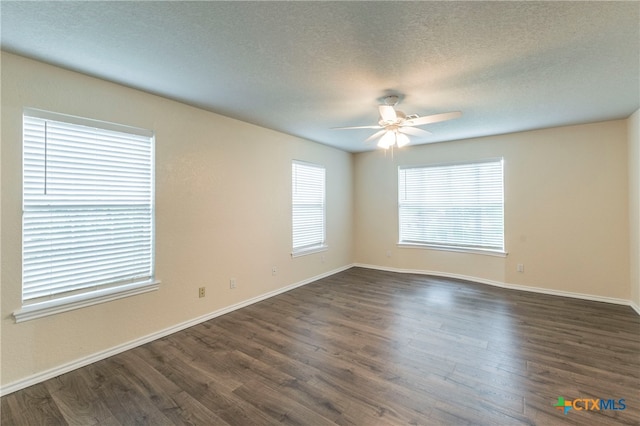 empty room featuring ceiling fan, a textured ceiling, and dark hardwood / wood-style flooring