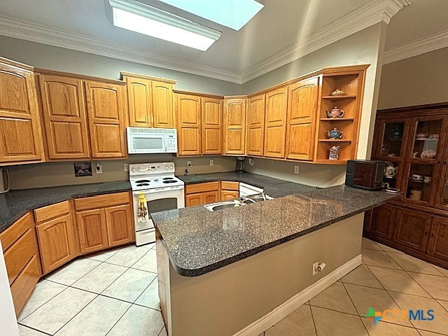 kitchen with crown molding, white appliances, sink, and light tile patterned floors