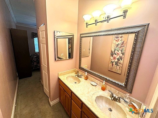 bathroom featuring crown molding and vanity