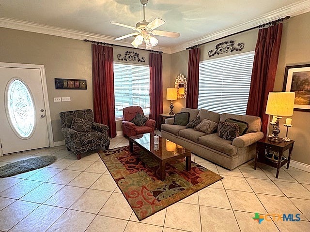 living room with crown molding, light tile patterned floors, and ceiling fan