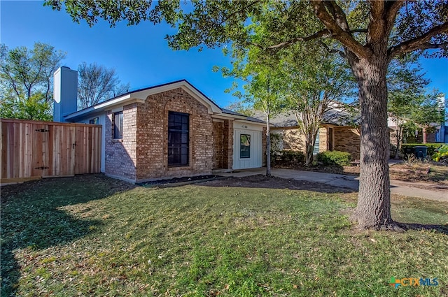 ranch-style house with a front lawn