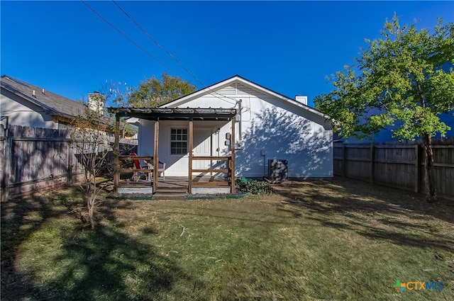 back of house featuring a deck and a yard