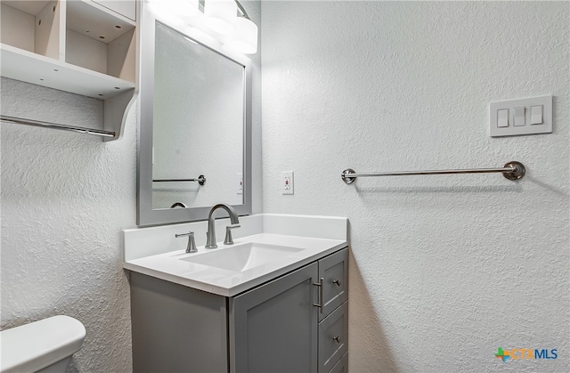 bathroom featuring toilet and vanity