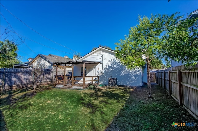 back of house with a yard and a wooden deck