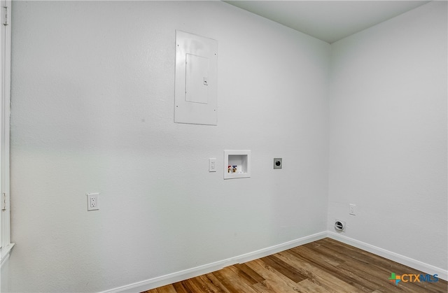 washroom featuring electric panel, hardwood / wood-style floors, hookup for a washing machine, and hookup for an electric dryer