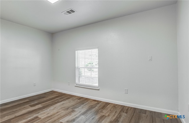 unfurnished room featuring wood-type flooring