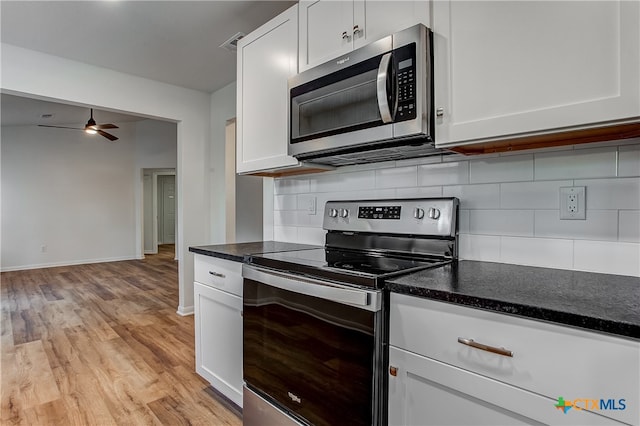 kitchen featuring white cabinetry, light wood-type flooring, and appliances with stainless steel finishes