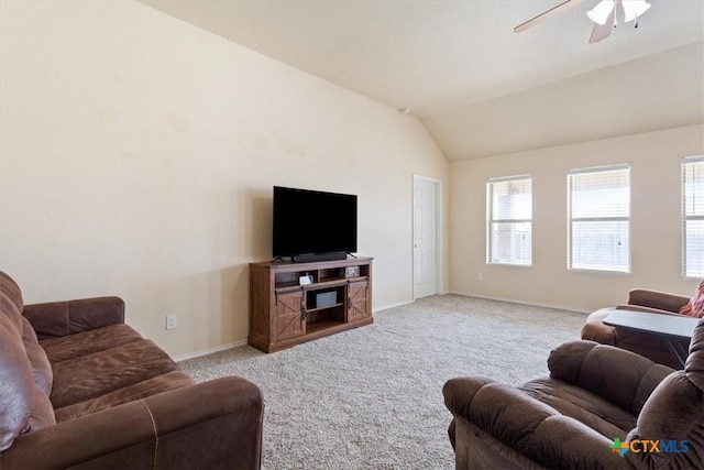 living area featuring a ceiling fan, carpet flooring, vaulted ceiling, and baseboards