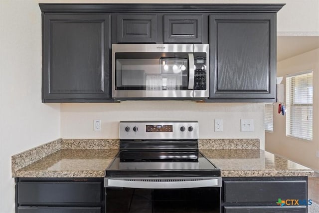 kitchen featuring stainless steel appliances and light countertops