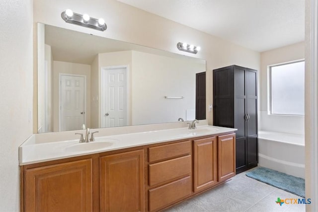 full bathroom with a sink, a bath, and double vanity