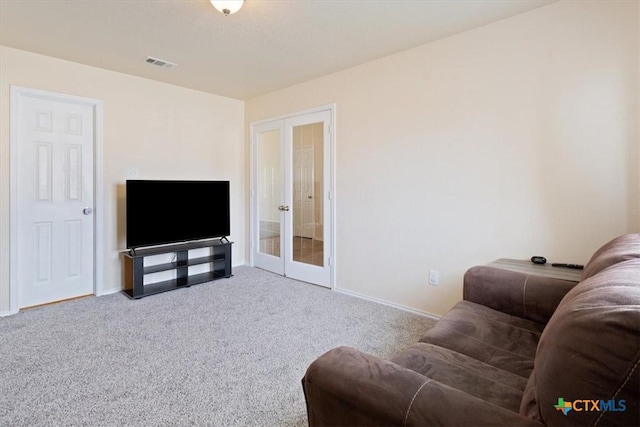 living area with baseboards, visible vents, carpet flooring, and french doors