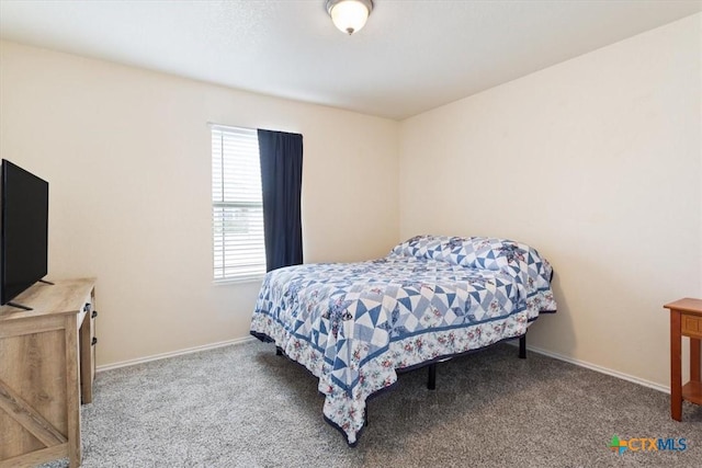 carpeted bedroom featuring baseboards