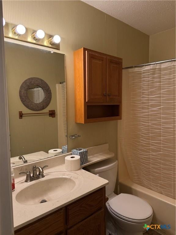 bathroom with a textured ceiling, toilet, shower / bath combo with shower curtain, and vanity