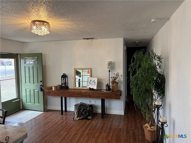 spare room with dark wood-type flooring and a textured ceiling