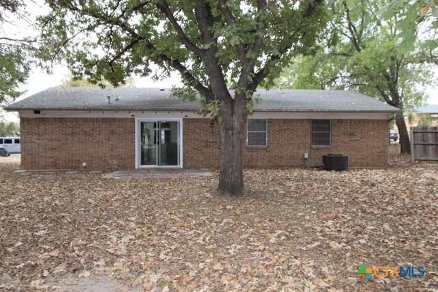 back of house featuring cooling unit