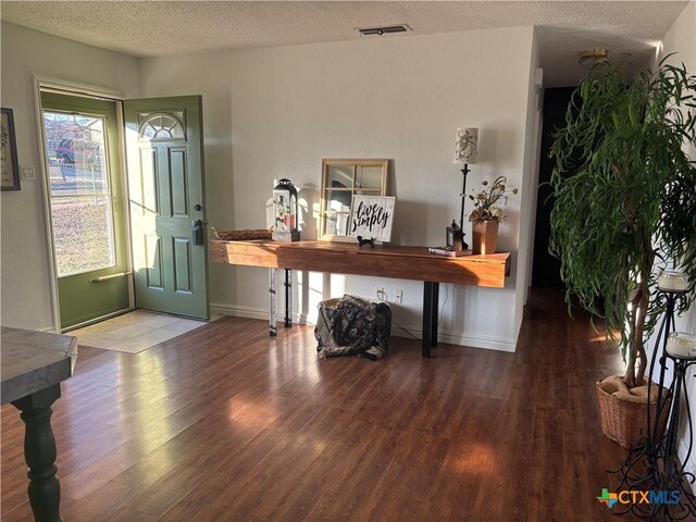 spare room with ceiling fan, dark hardwood / wood-style flooring, and a textured ceiling