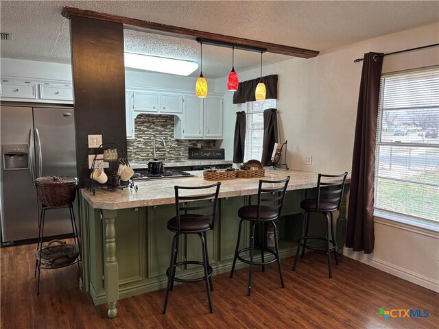 kitchen with tasteful backsplash, white cabinetry, appliances with stainless steel finishes, and sink