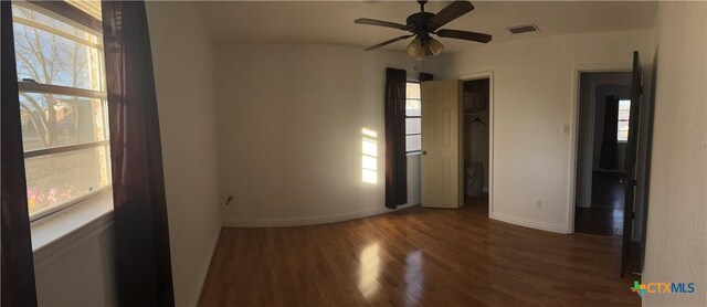 full bathroom with tile walls, tiled shower / bath combo, vanity, toilet, and tile patterned floors