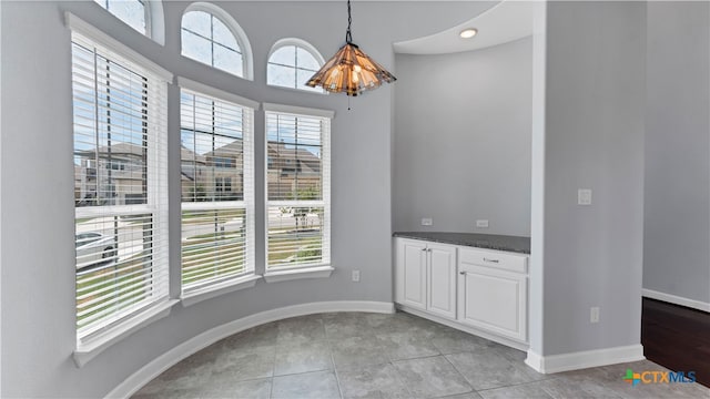 unfurnished dining area with light tile patterned floors