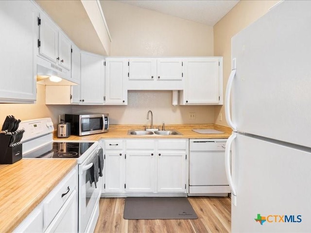 kitchen featuring vaulted ceiling, sink, white cabinets, and white appliances