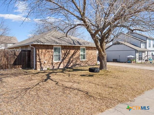 view of side of home featuring a yard