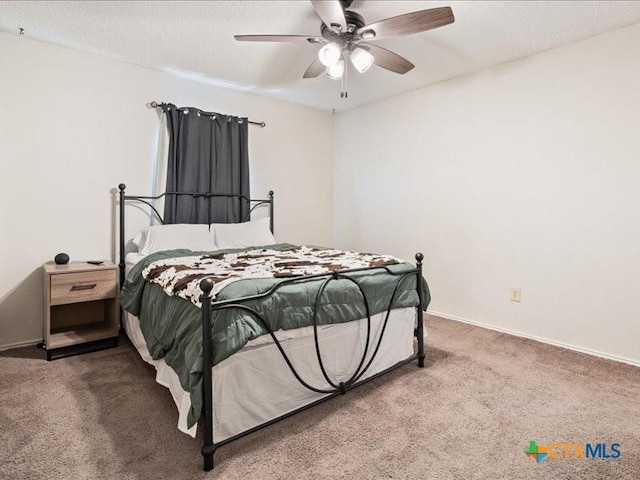 bedroom with carpet flooring, a textured ceiling, and ceiling fan