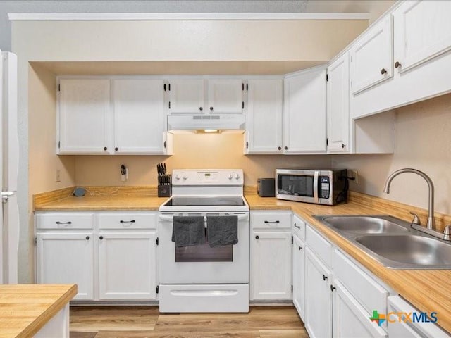 kitchen with sink, white cabinets, white appliances, and light wood-type flooring