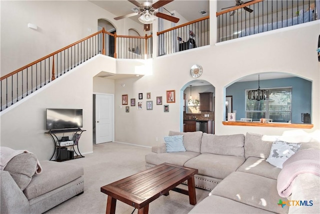 5310 Dauphin Dr, Belton, TX 76513 - carpeted living area with ceiling fan with notable chandelier, arched walkways, baseboards, and stairs