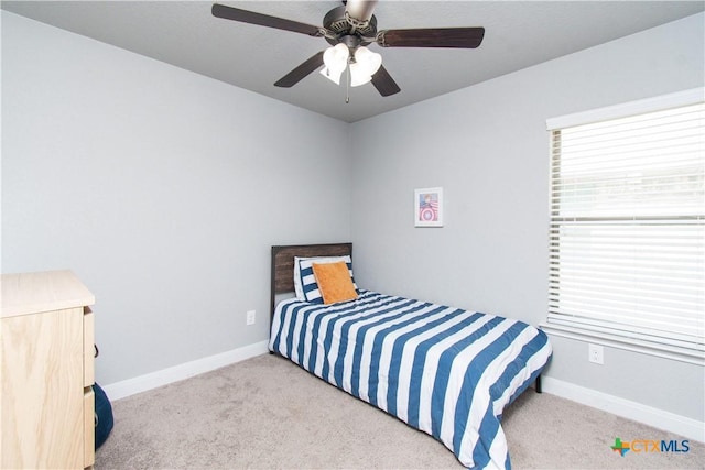 carpeted bedroom with baseboards and ceiling fan