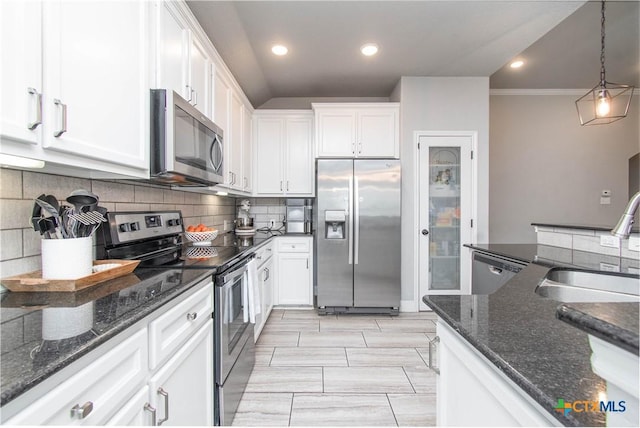 kitchen with a sink, stainless steel appliances, backsplash, and white cabinets