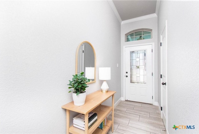 foyer entrance with baseboards and ornamental molding