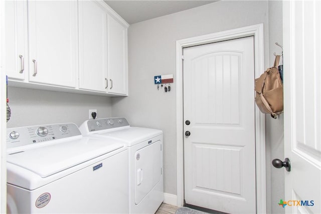 clothes washing area with cabinet space and washing machine and clothes dryer