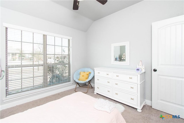 bedroom with vaulted ceiling, a ceiling fan, baseboards, and light carpet