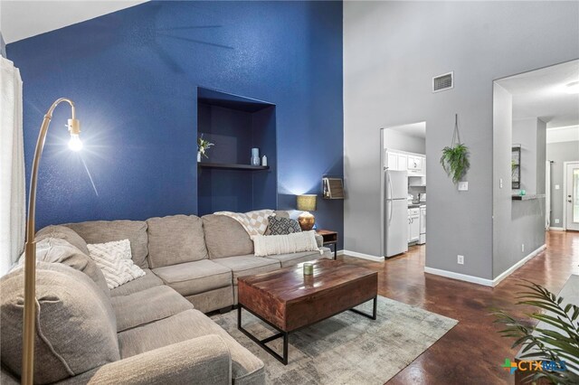 109 Dolly St, San Marcos, TX 78666 - living area with concrete floors and a towering ceiling