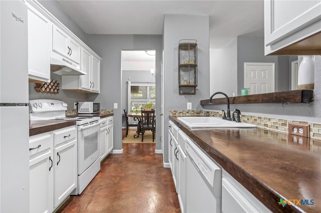 109 Dolly St, San Marcos, TX 78666 - kitchen with white appliances, under cabinet range hood, finished concrete floors, white cabinets, and backsplash