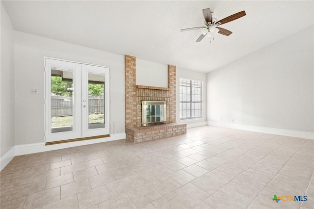 2209 Winchester Dr, Temple, TX 76502 - unfurnished living room with french doors, ceiling fan, lofted ceiling, light tile patterned flooring, and a fireplace
